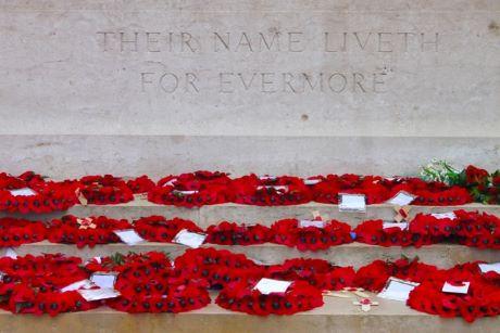 Wreaths of red poppies on war memorial engraved "Their name liveth for evermore"